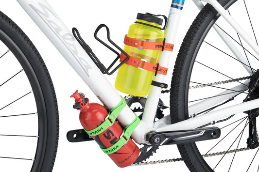 A bike shown from the side features multiple bottles attached with Bow Tie Strap Anchors.
